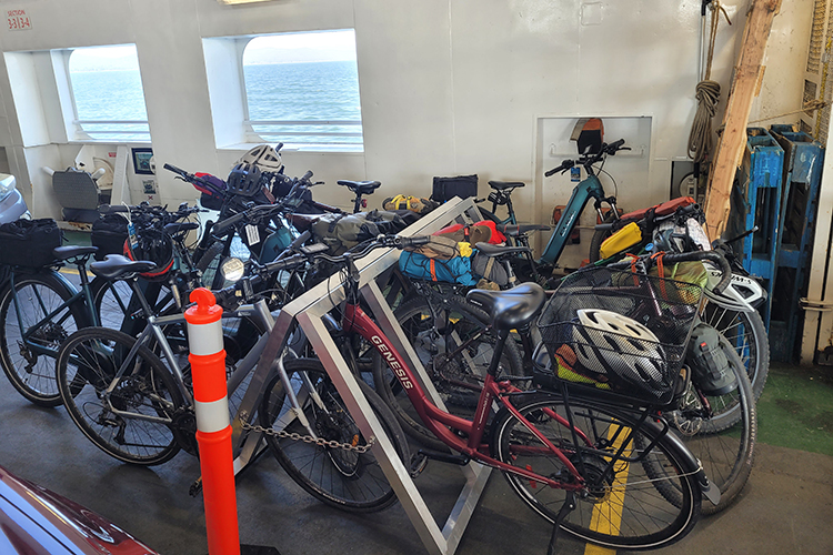 Several bikes secured on bike racks onboard the ferry