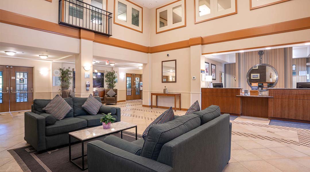 The lobby of the Sandman Hotel and Suites Squamish with the check-in desk and couches