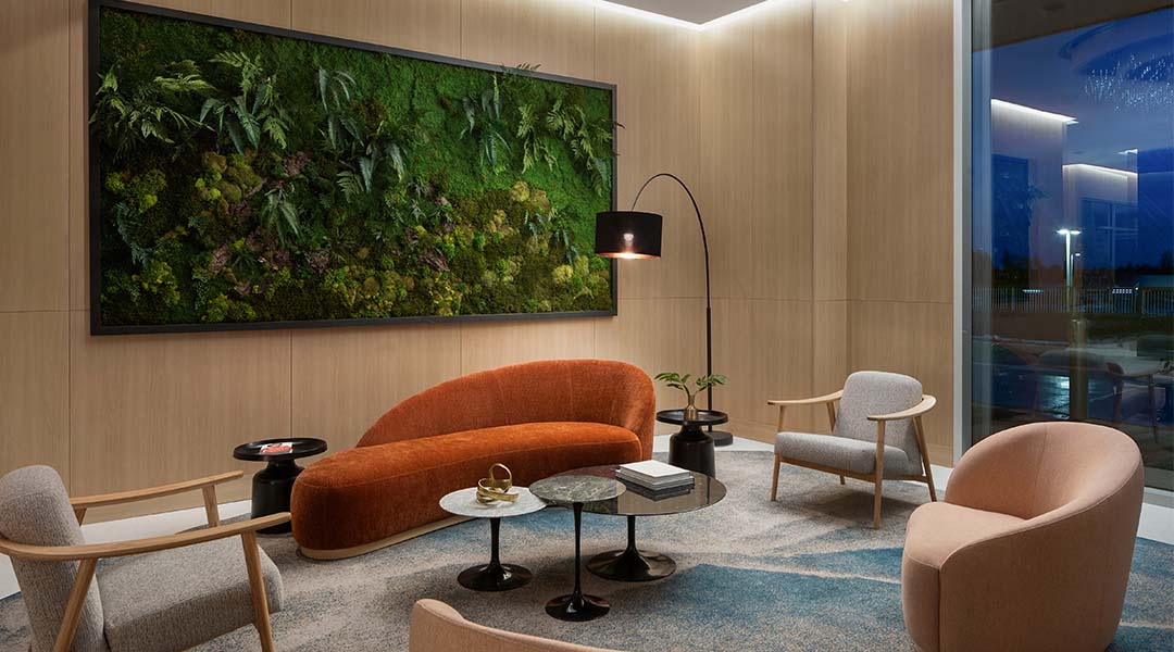 Modern hotel lobby with contemporary seating and vertical living wall