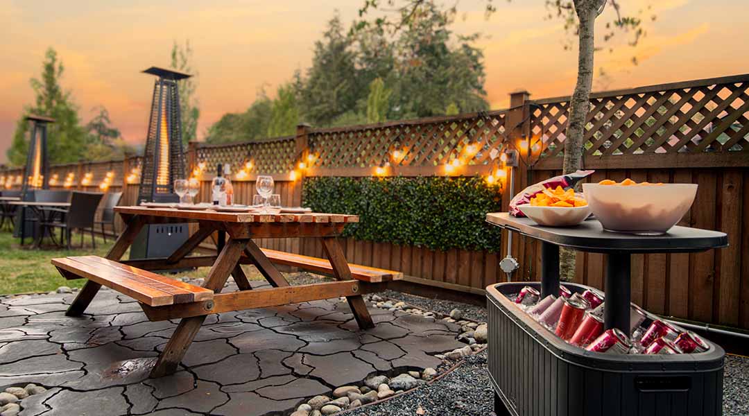 Outdoor picnic area at the Coast Parksville Hotel featuring picnic tables, snacks, and a cooler of drinks