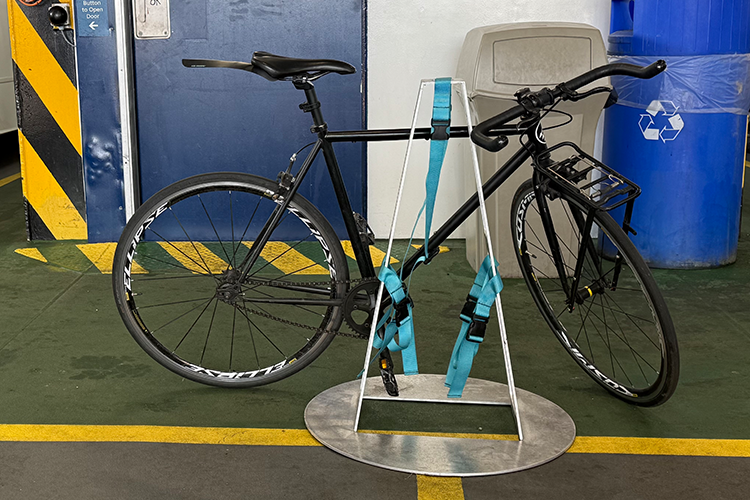 A bike locked on a bike rack on the ferry