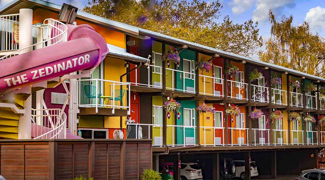 Exterior of Hotel Zed Victoria with pink waterslide called the Zedinator
