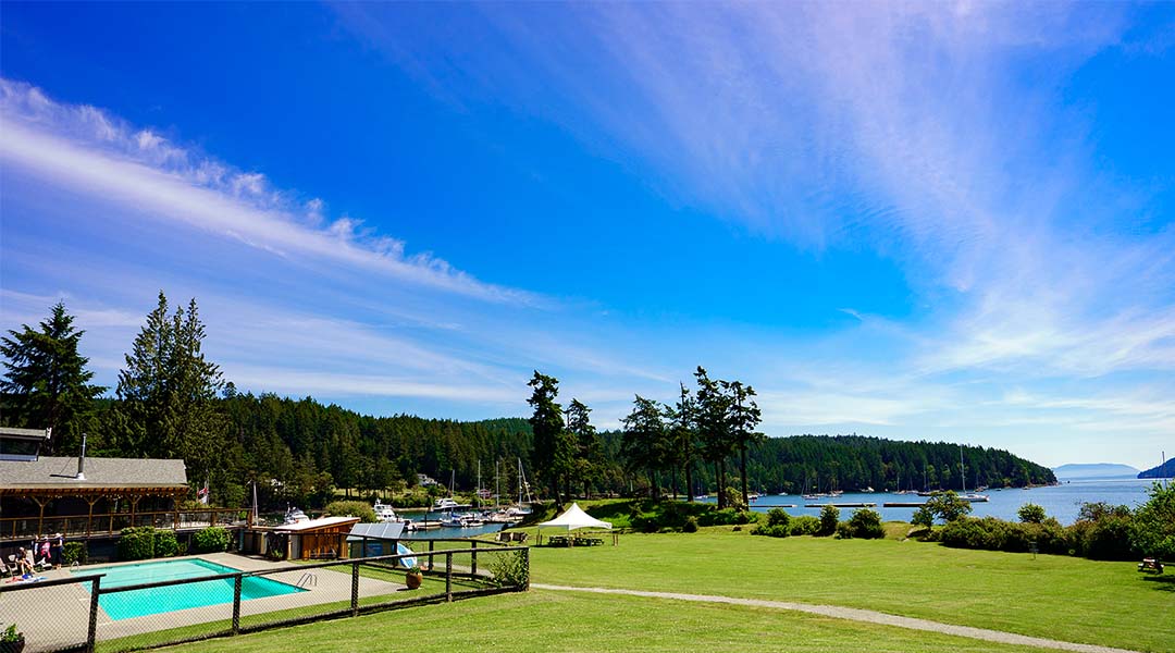 Exterior shot of property with pool and ocean