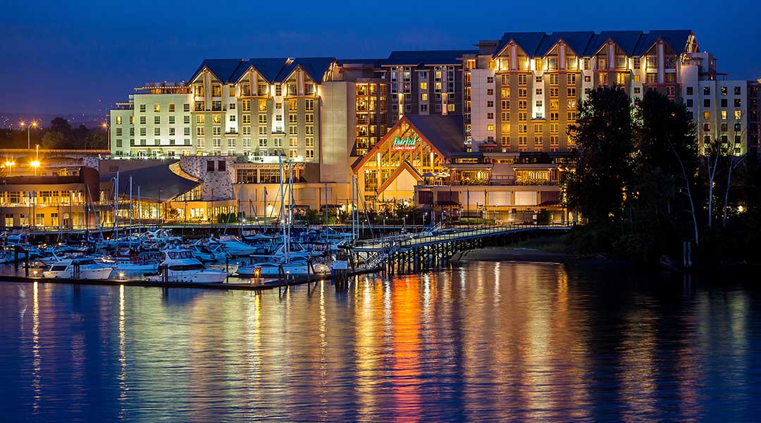 Exterior of River Rock Casino Resort reflecting on water in the evening in Richmond