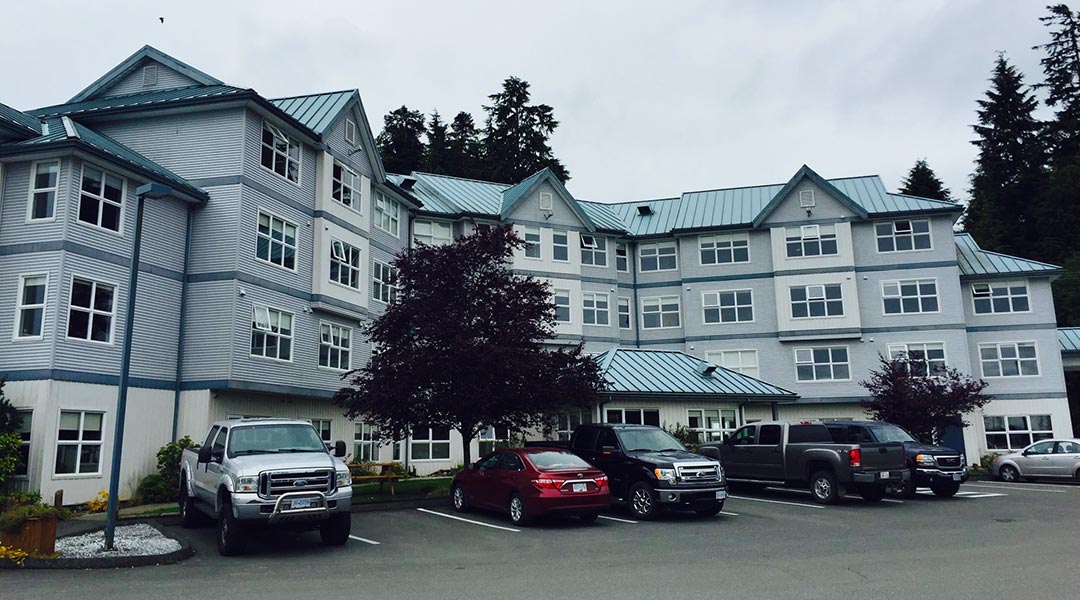 Exterior of the Quarterdeck Resort and Marina in Port Hardy and parking lot