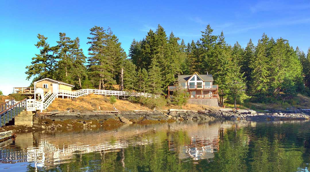 The exterior building of the Gowlland Harbour Resort by the ocean on Quadra Island