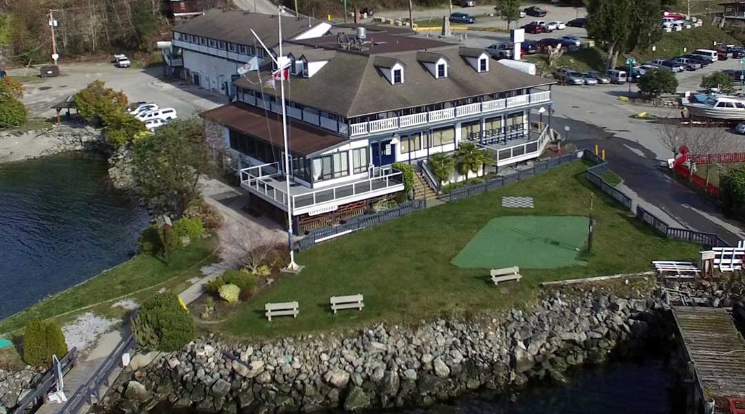 Aerial view of The Lund Resort at Klah Ah Men with front lawn and ocean near Powell River BC on the Sunshine Coast