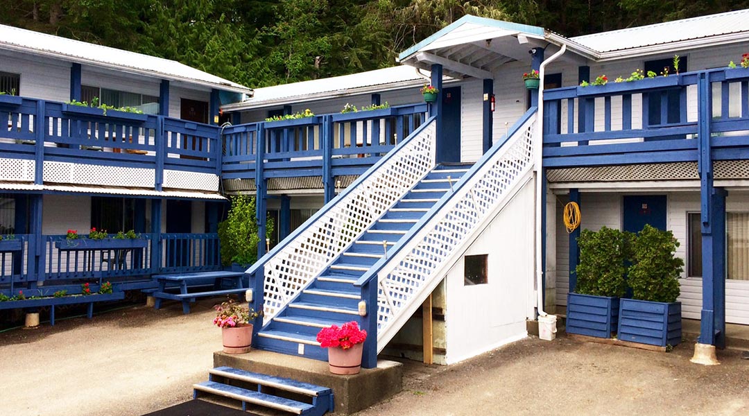 Close up of the exterior building and parking area of the Sea Raven Motel in Queen Charlotte Haida Gwaii