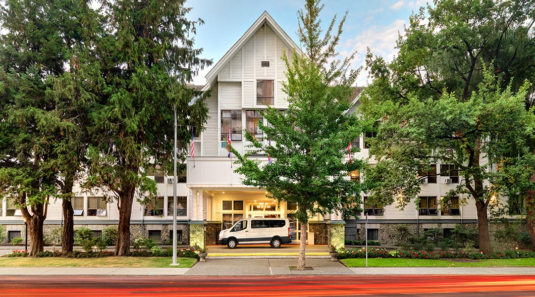 Exterior of Huntingdon Manor in Victoria with trees in full bloom
