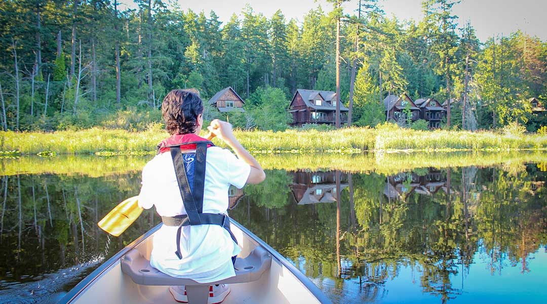 Person canoeing on Bullocks Lake near the Cottages on Salt Spring Island
