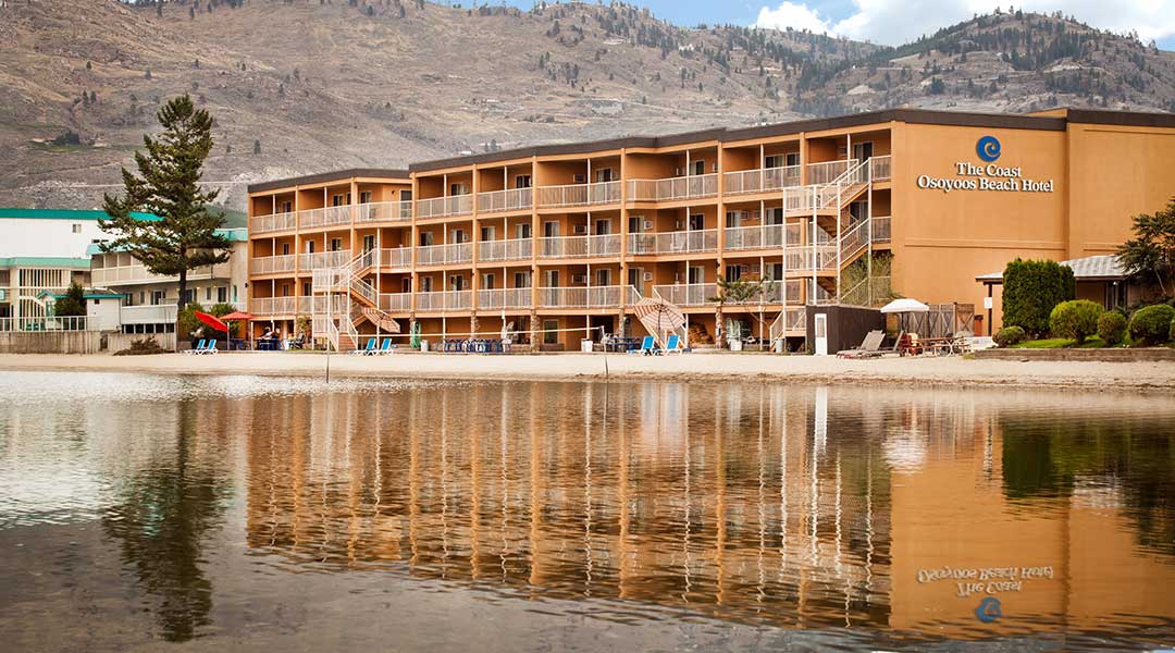 The exterior building of the Coast Osoyoos Beach Hotel by the lake in Thompson Okanagan