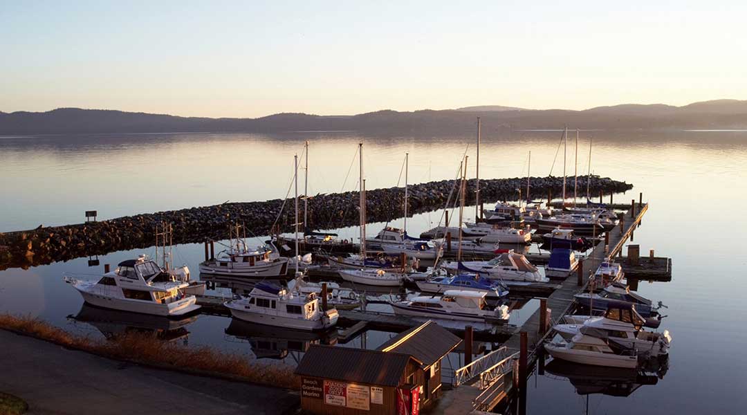 Boats docked at the Beach Gardens Resort and Marina in Powell River on the Sunshine Coast at sunset