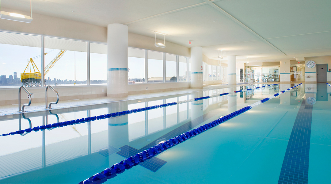 Indoor pool with windows looking out to ocean at the Pinnacle Hotel at the Pier in North Vancouver