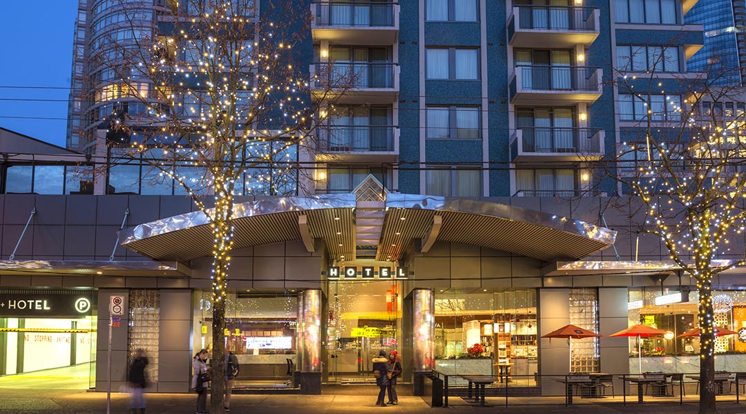 The exterior of the Blue Horizon Hotel in Vancouver at night