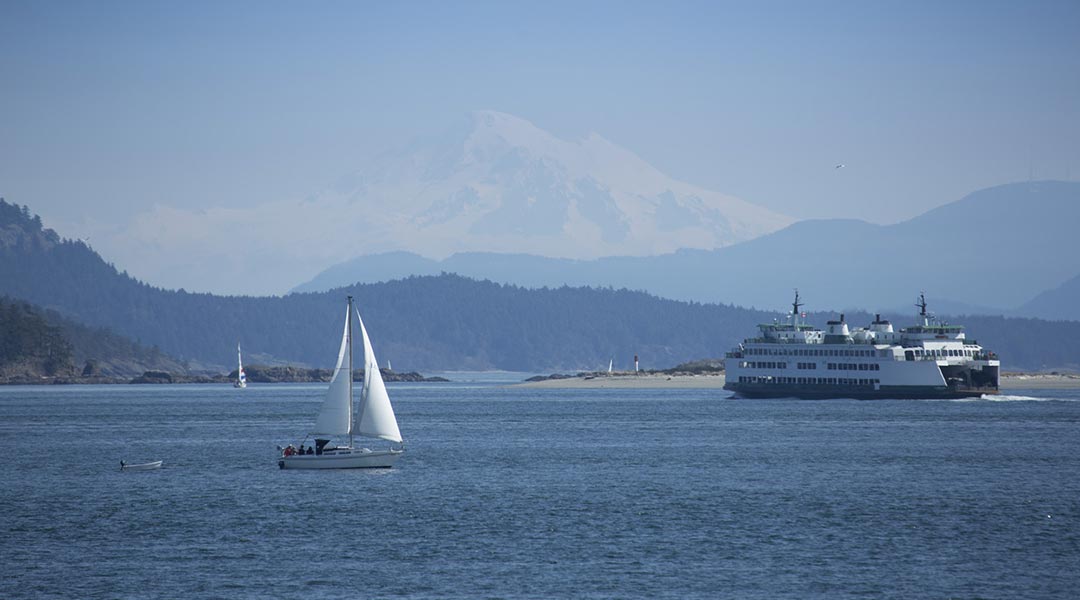 The ocean and mountain views with boats outside the Sidney Waterfront Inn and Suites on Vancouver Island
