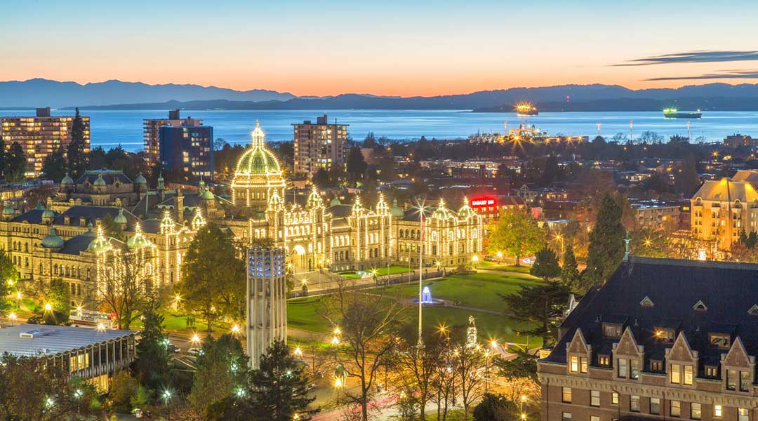 Skyline of Victoria with view of parliament and ocean at dusk from The Embassy Inn in Victoria BC