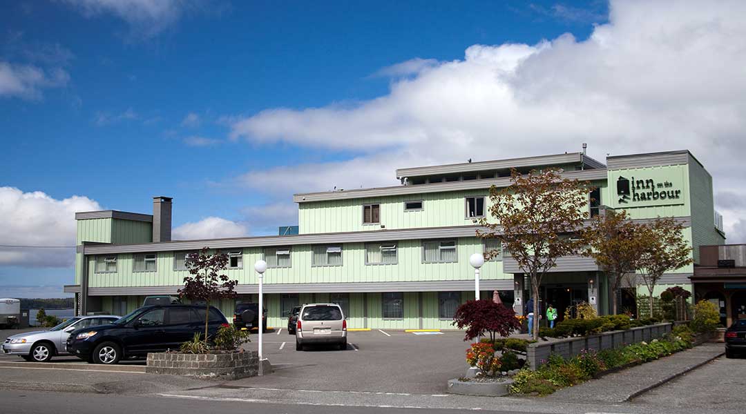 Exterior of Inn on the Harbour in Prince Rupert with parking lot out front