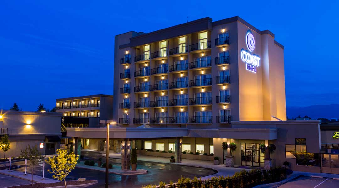 The exterior entrance and building of the Coast Capri Hotel in Kelowna in the Thompson Okanagan in the evening