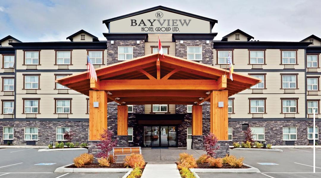 The exterior building and entrance of the Bayview Hotel Group Ltd in Comox and parking lot