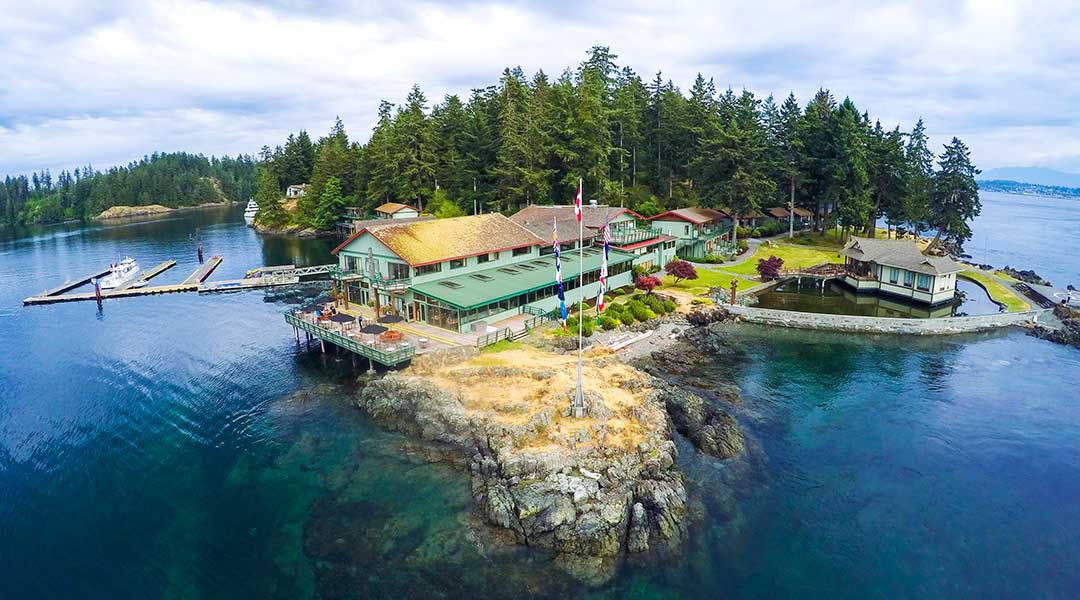 An aerial view of the exterior of the April Point Resort and Spa surrounded by the ocean in Quathiaski Cove on Quadra Island