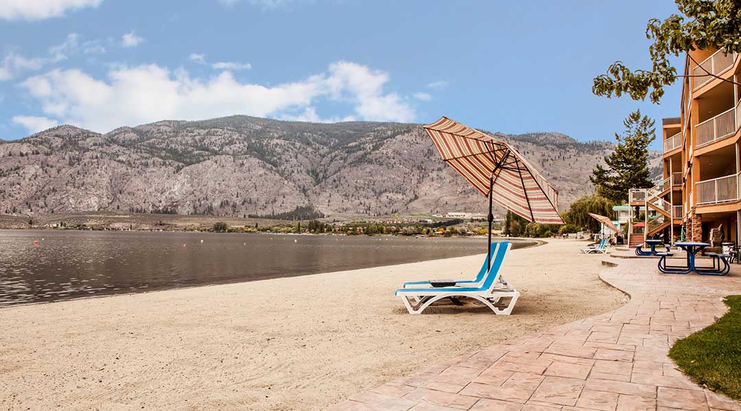 Beach chair in front of a lake outside the Coast Osoyoos Beach Hotel in Thompson Okanagan