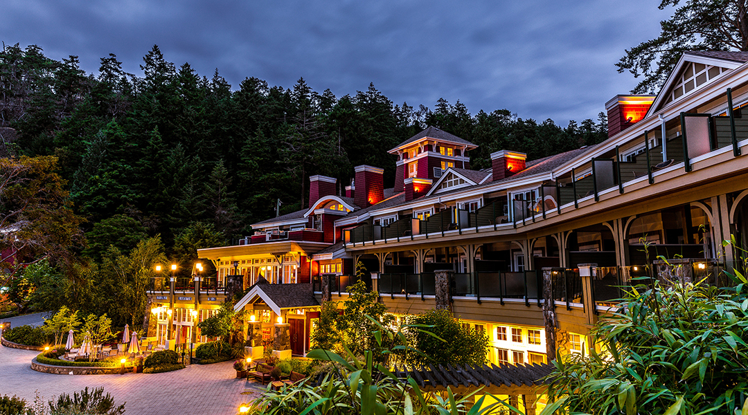 Exterior of Poets Cove Resort and Spa at night with evening lights on Pender Island