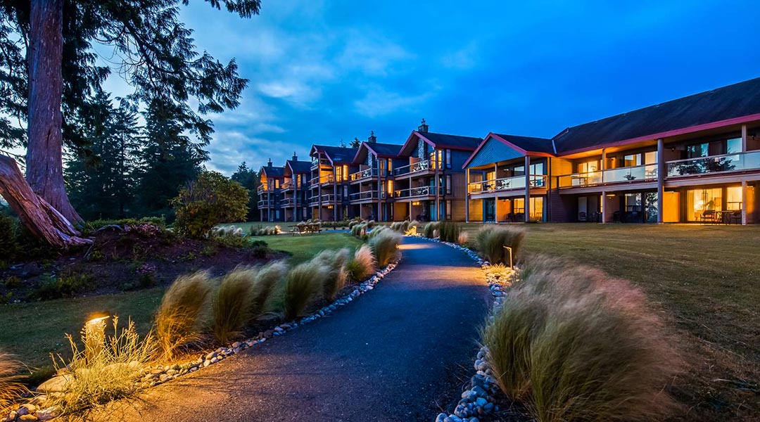 Pathway and exterior building of the Best Western Plus Tin Wis Resort at dusk in Tofino