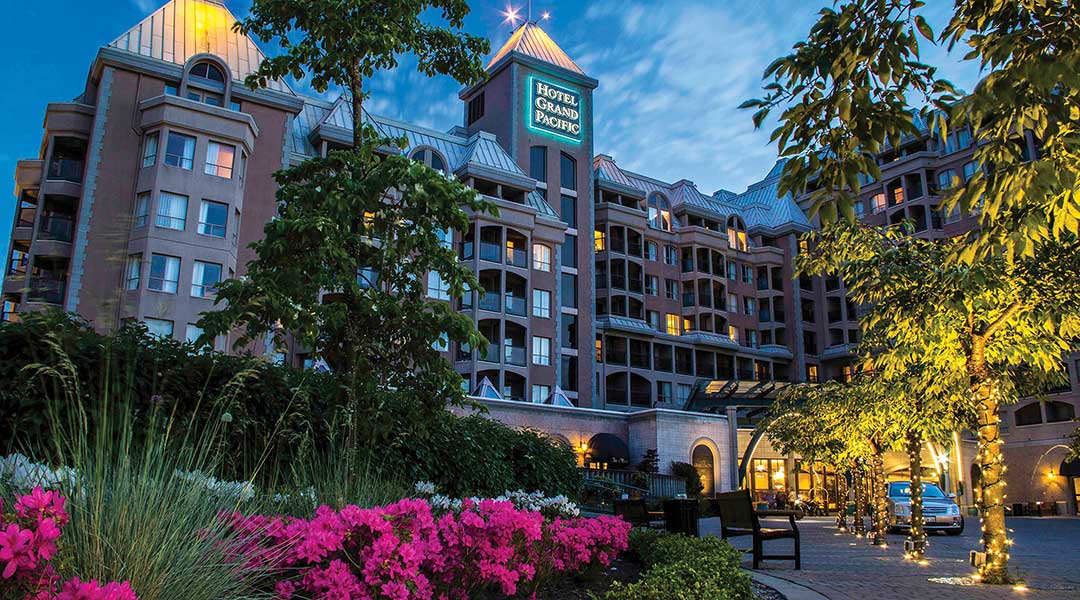The exterior driveway and building of the Hotel Grand Pacific in Victoria BC by the harbour