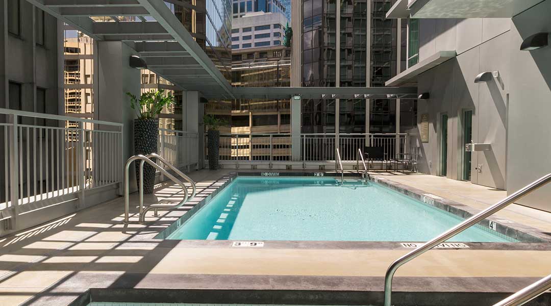 The outdoor pool and hot tub at the Coast Coal Harbour Hotel by APA in Vancouver