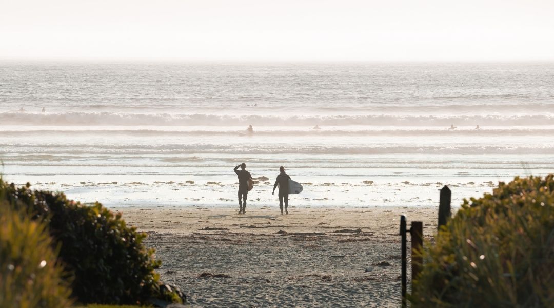 Two people surfing at Long Beach Lodge Resort in Tofino